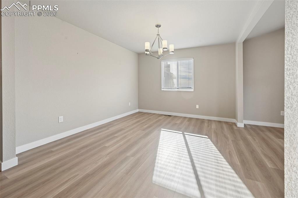 Image 6 of 42: Unstaged formal dining room, can be used as office! 