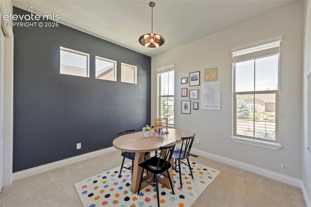 Image 12 of 38: Bedroom on main level currently being used as a home school
