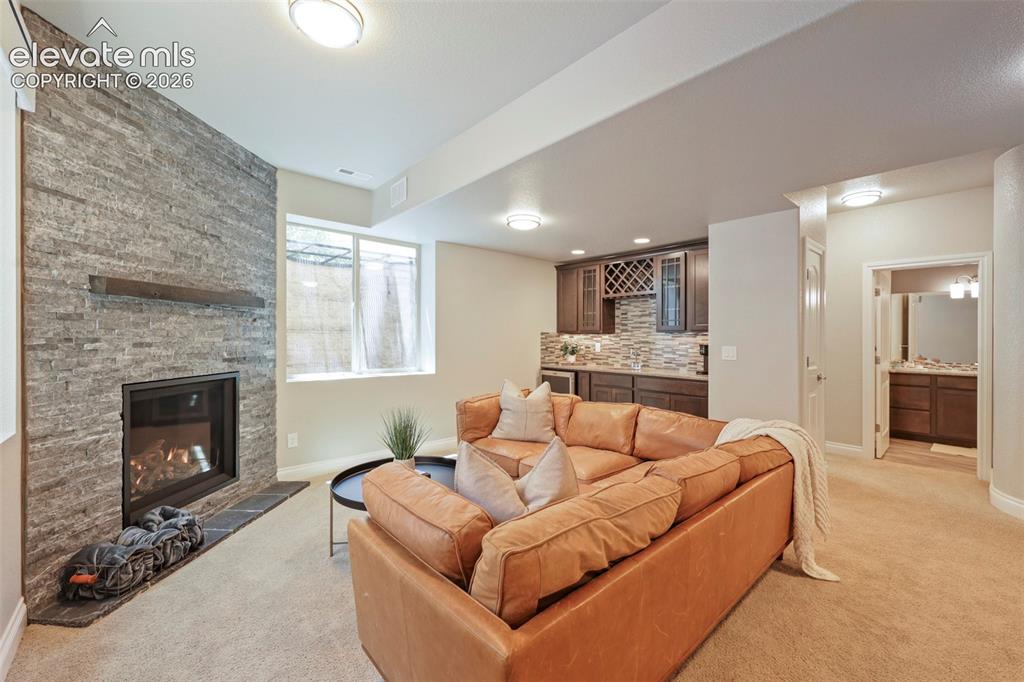 Image 28 of 38: Downstairs with a gas fireplace