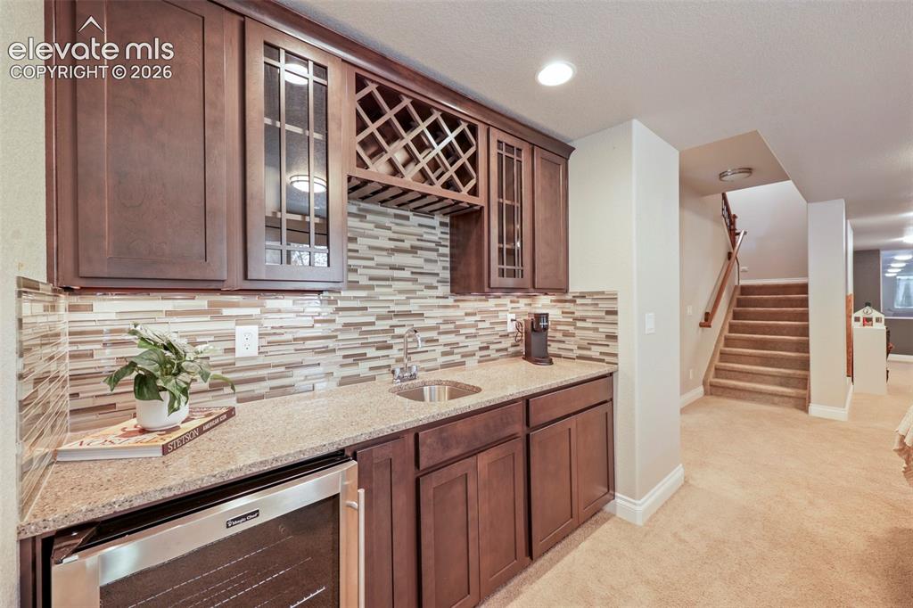 Image 30 of 38: Wet bar in the basement