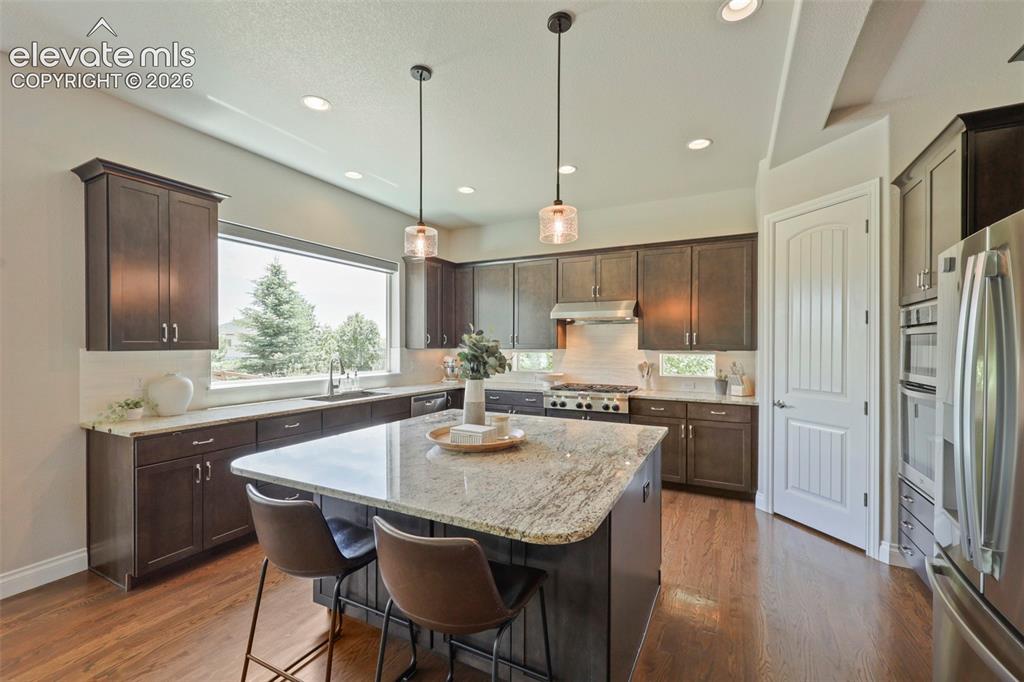 Image 9 of 38: Showcasing window over kitchen sink with views