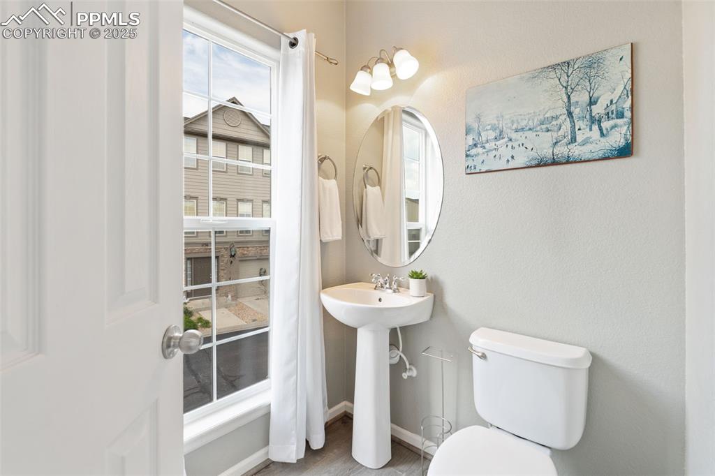 Image 16 of 35: Half bath featuring toilet and wood finished floors