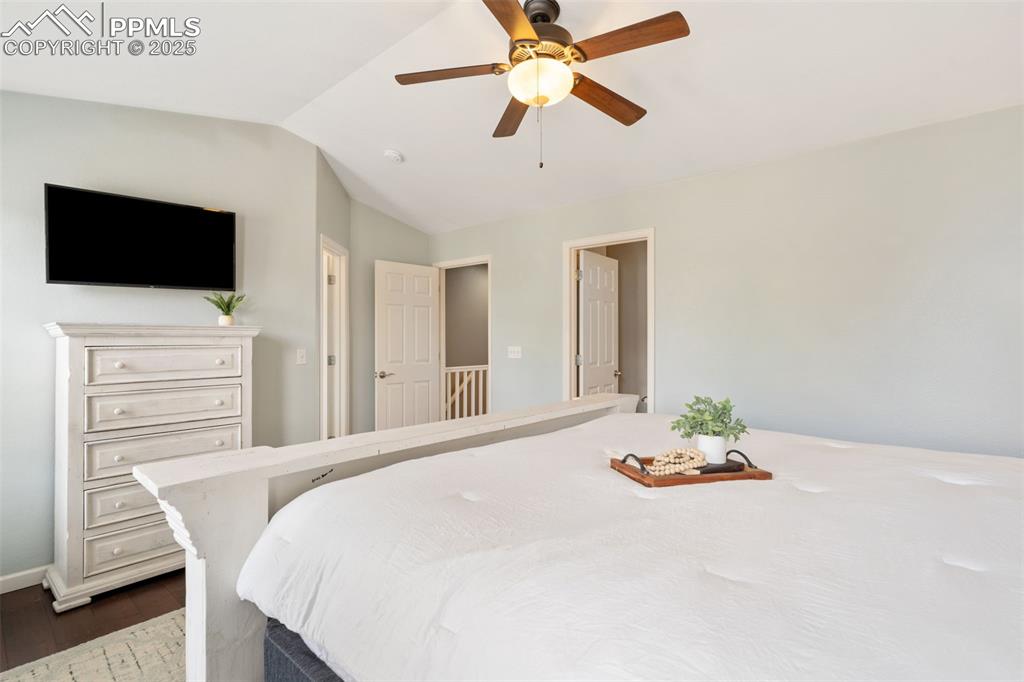 Image 19 of 35: Bedroom featuring lofted ceiling, dark wood-style floors, and ceiling fan