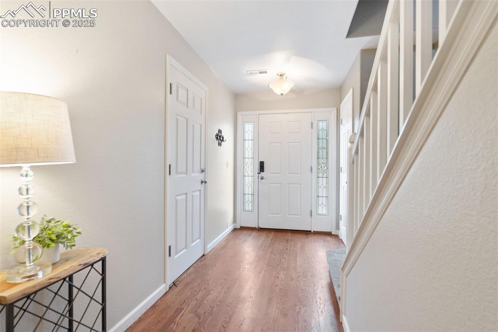 Image 2 of 35: Foyer featuring wood finished floors and stairs