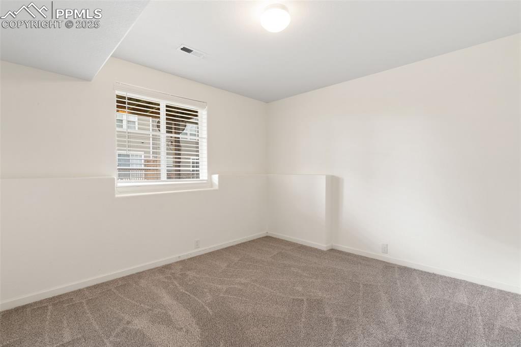 Image 26 of 35: Carpeted empty room with baseboards