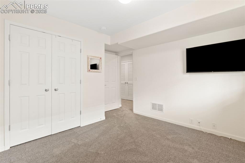 Image 27 of 35: Unfurnished bedroom with carpet flooring and a closet