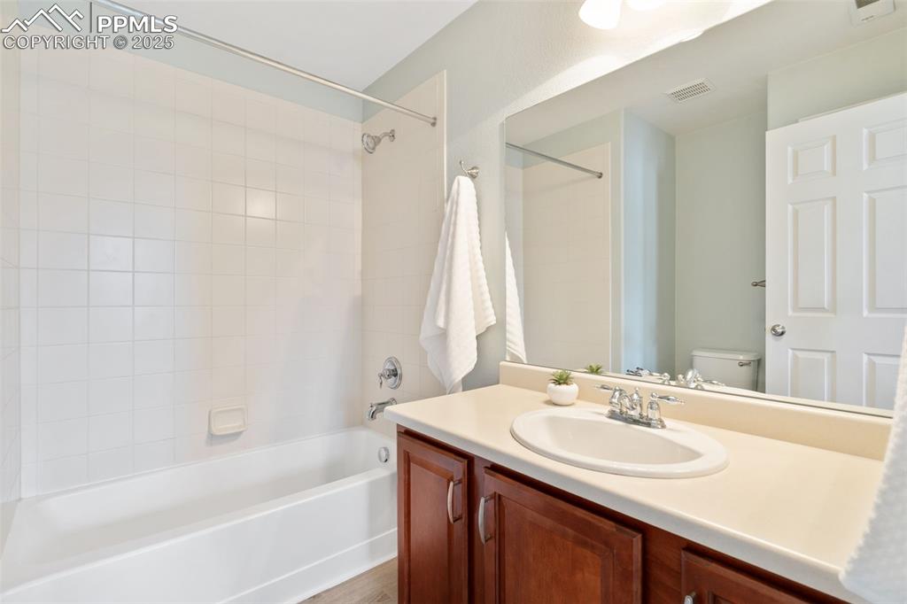 Image 29 of 35: Bathroom featuring shower / tub combination and vanity