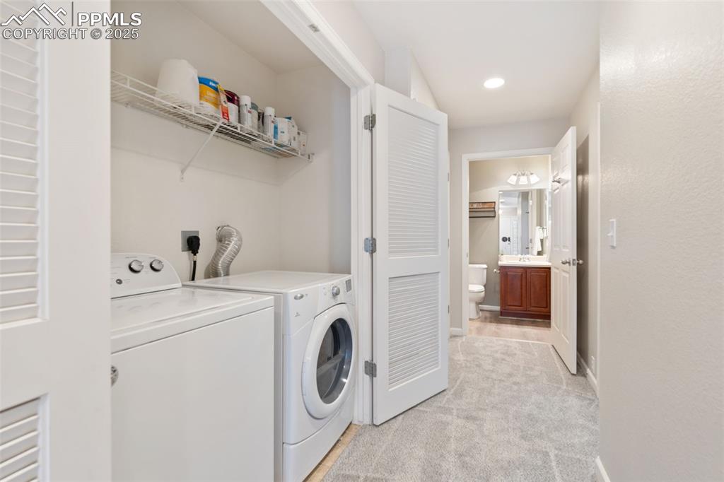 Image 30 of 35: Washroom featuring light colored carpet, separate washer and dryer, and rec