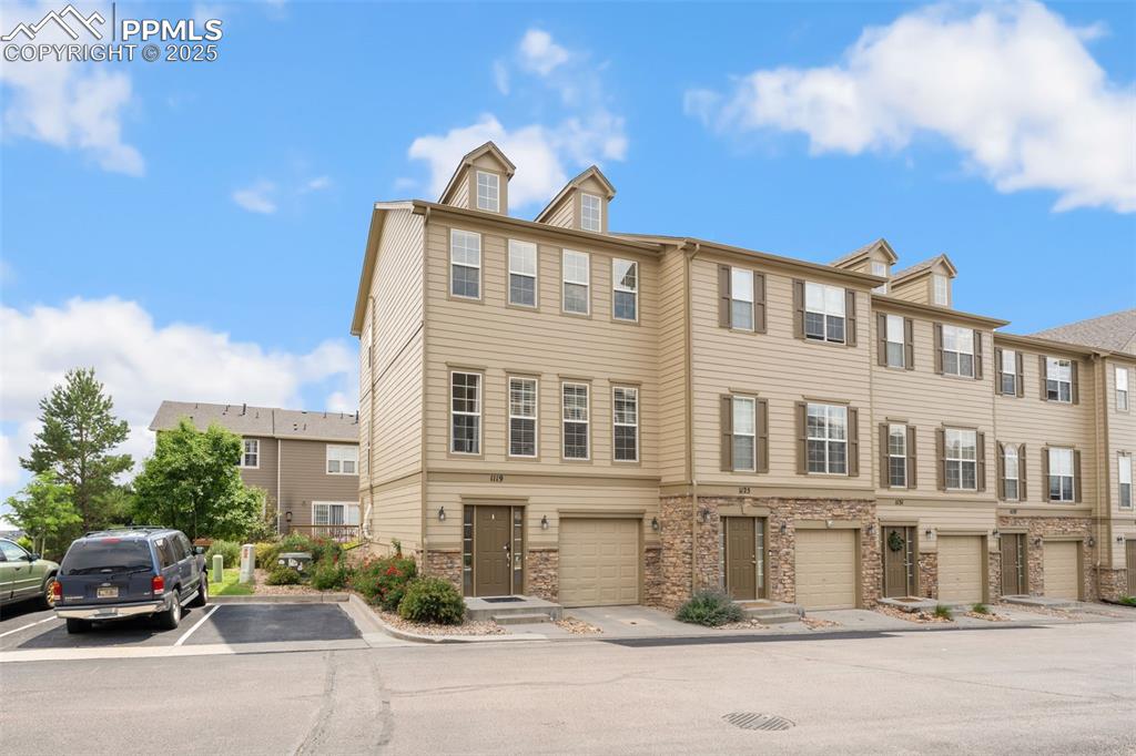 Image 34 of 35: View of front of home featuring stone siding, a residential view, and uncov