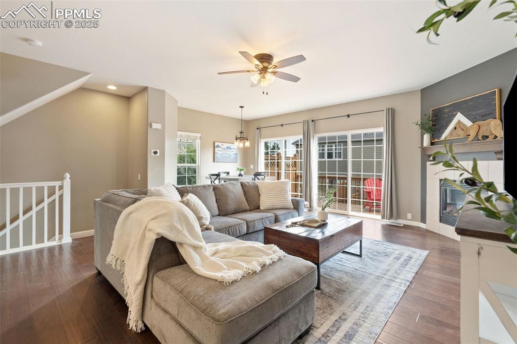 Image 5 of 35: Living room featuring ceiling fan, dark wood-type flooring, and recessed li