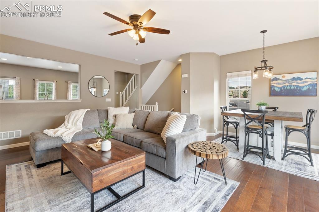 Image 7 of 35: Living room with healthy amount of natural light, hardwood / wood-style flo