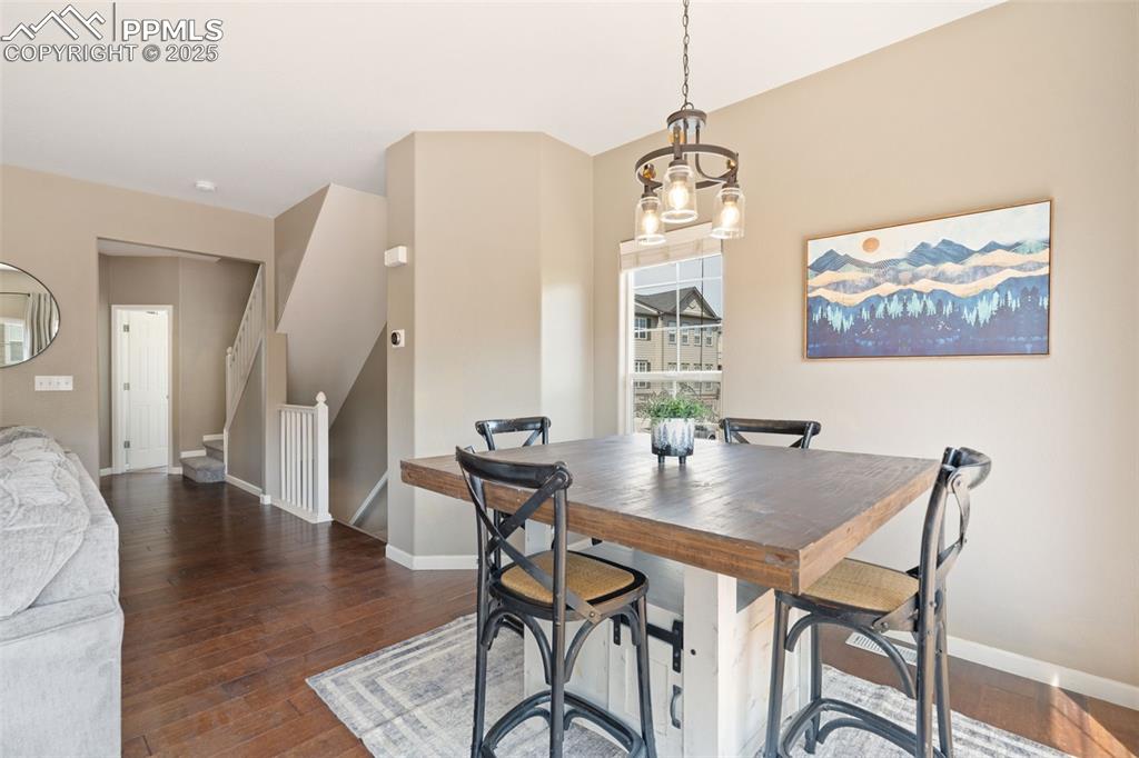 Image 8 of 35: Dining area featuring hardwood / wood-style flooring and stairs