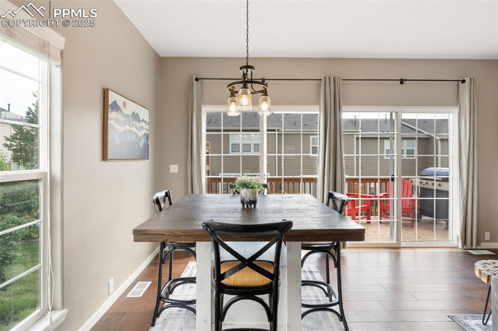 Image 9 of 35: Dining room featuring a chandelier and wood finished floors