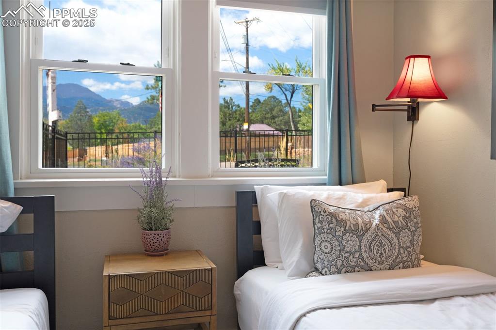 Image 16 of 42: 2nd bedroom with mountain views