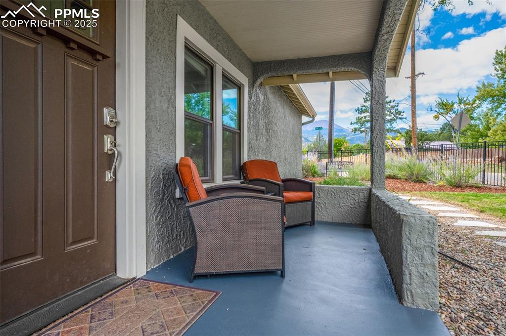 Image 22 of 42: Covered front porch with mountain views