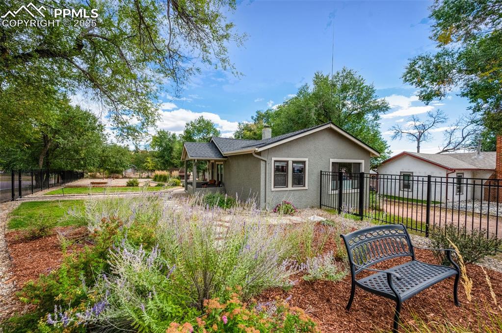 Image 26 of 42: A bench in the garden to admire the Pikes Peak Views!