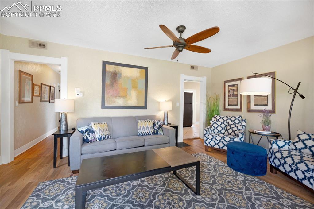 Image 4 of 42: Glowing wood floors in living room