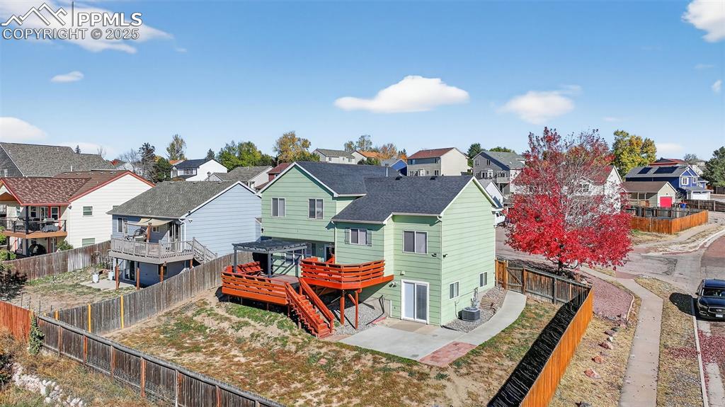 Image 3 of 29: Back of house featuring a residential view, a fenced backyard, a patio area
