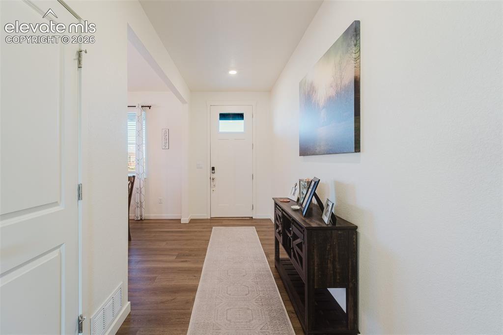 Image 12 of 48: Beautiful wood laminate floors throughout the entry and most of the main le