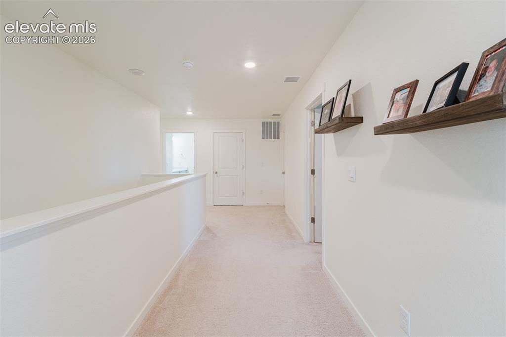 Image 23 of 47: Upper level hallway to the Primary Bedroom.