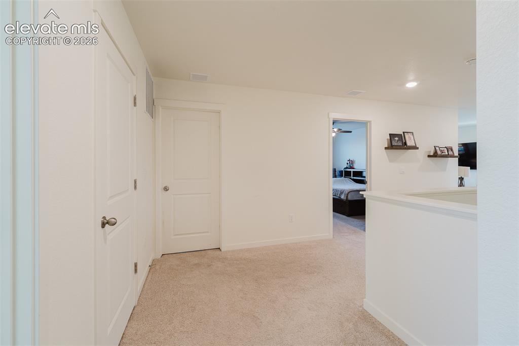 Image 29 of 47: Hallway to upper level secondary bedrooms.