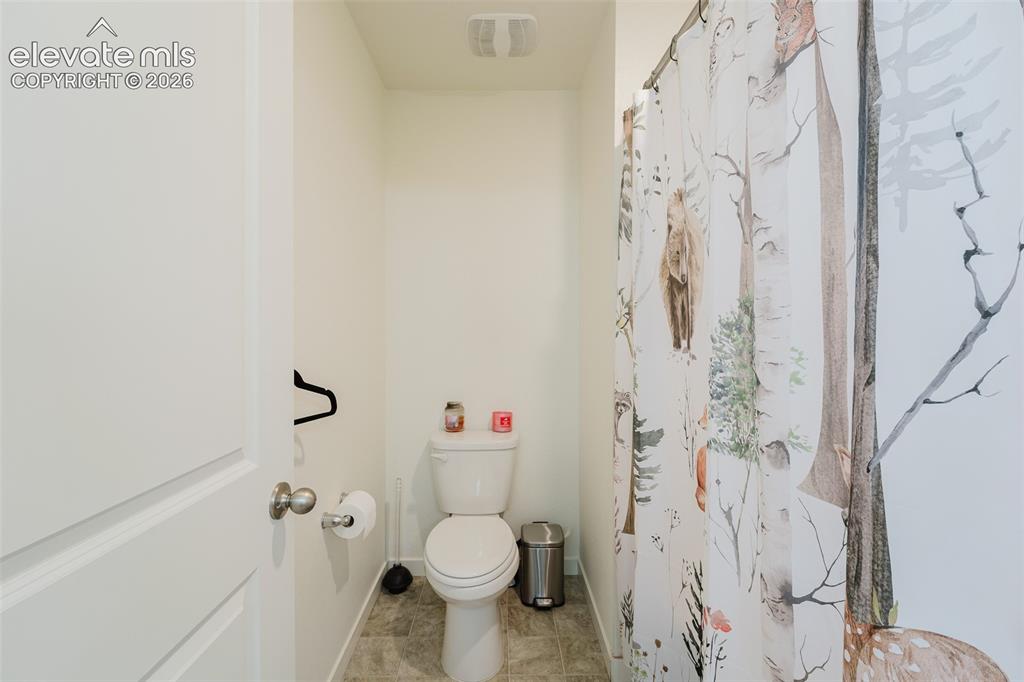 Image 35 of 48: Toilet Room and tub/shower in upper level Hall Bathroom.