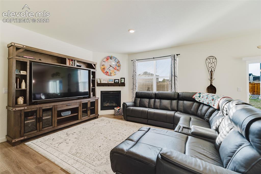 Image 5 of 48: The spacious Living Room features a gas fireplace to cozy up on chilly Colo