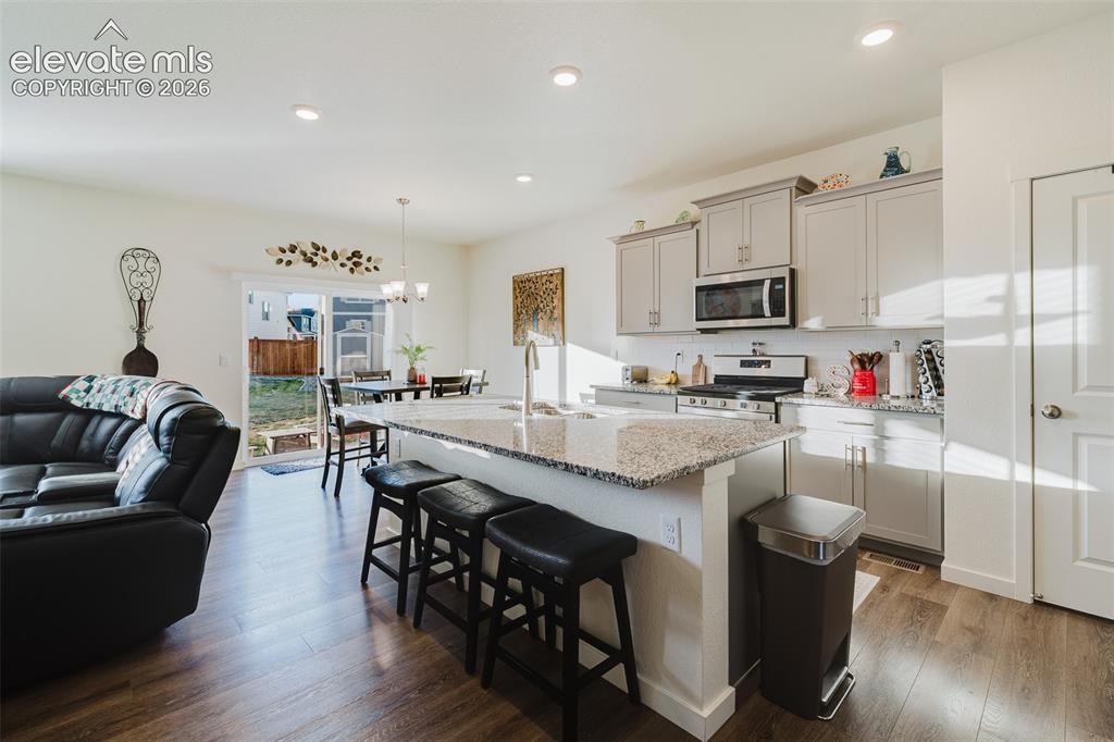 Image 8 of 47: Open main level where the Living Room, Dining Nook, and Kitchen flow seamle