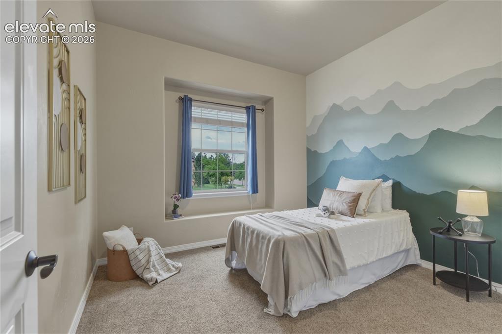 Image 24 of 49: Neutral tone wall paint, carpet flooring, window with blinds, window sill, 