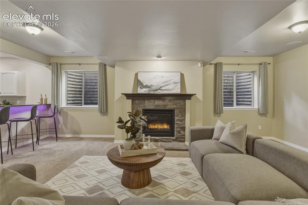 Image 28 of 49: Stone-clad fireplace with a wood mantel