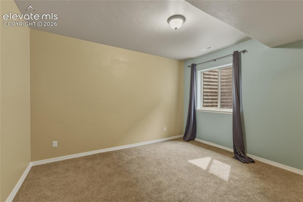 Image 33 of 49: Recessed window with white trim, wall-to-wall carpeting, and a flush mount 