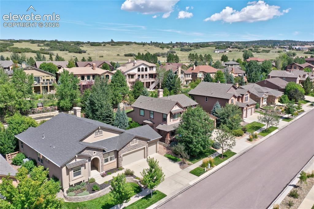 Image 43 of 49: Single-story property with a two-car garage, stone and stucco exterior, and