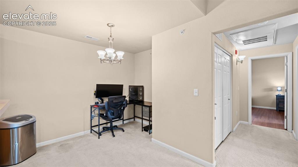 Image 12 of 33: Neutral-toned walls complement light-colored carpeting