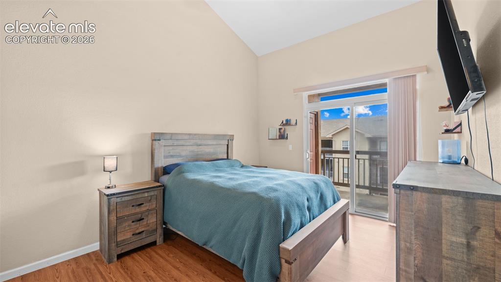 Image 13 of 33: Room featuring vaulted ceilings and wood-finish flooring
