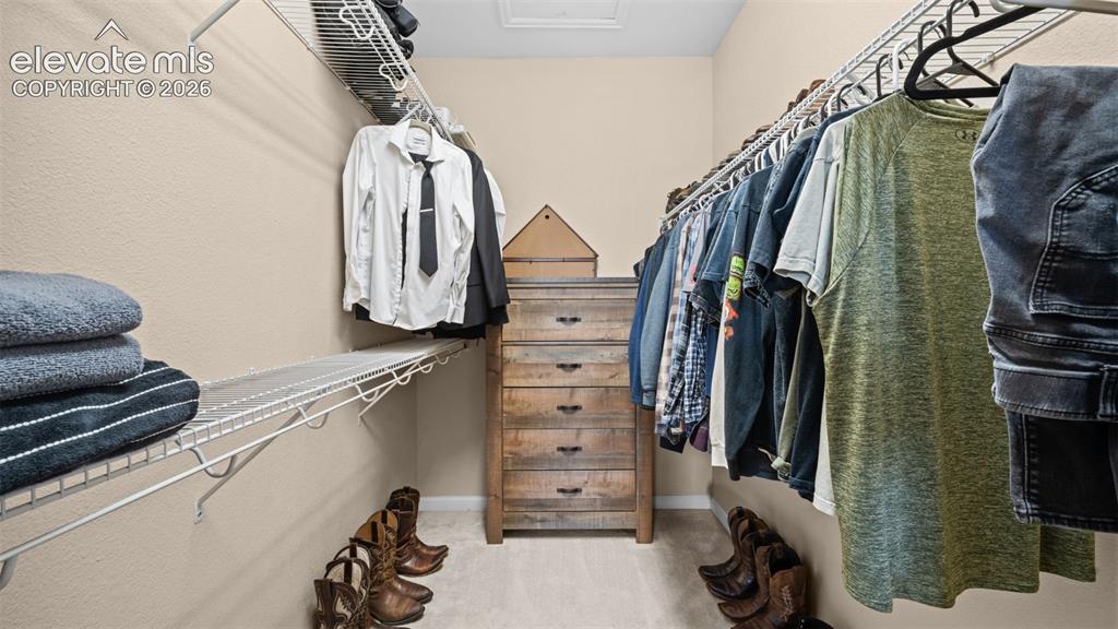 Image 15 of 33: Walk-in closet featuring wire shelving, hanging rods, and light-toned wall