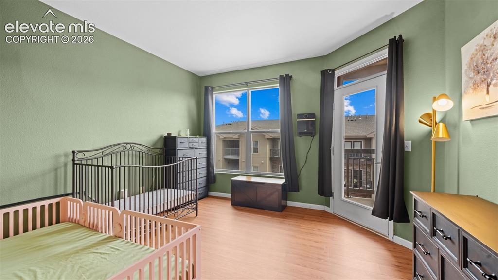 Image 19 of 33: Room featuring light green walls and wood-finish flooring
