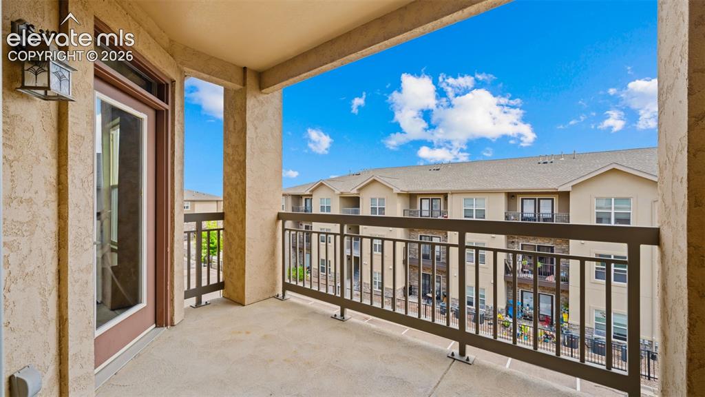 Image 22 of 33: Private balcony featuring a concrete floor, stucco walls, and a dark metal