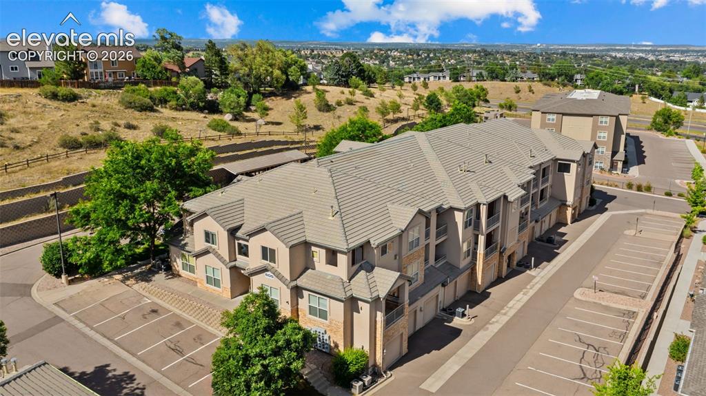 Image 26 of 33: Multi-story residential building featuring a neutral-toned exterior with st