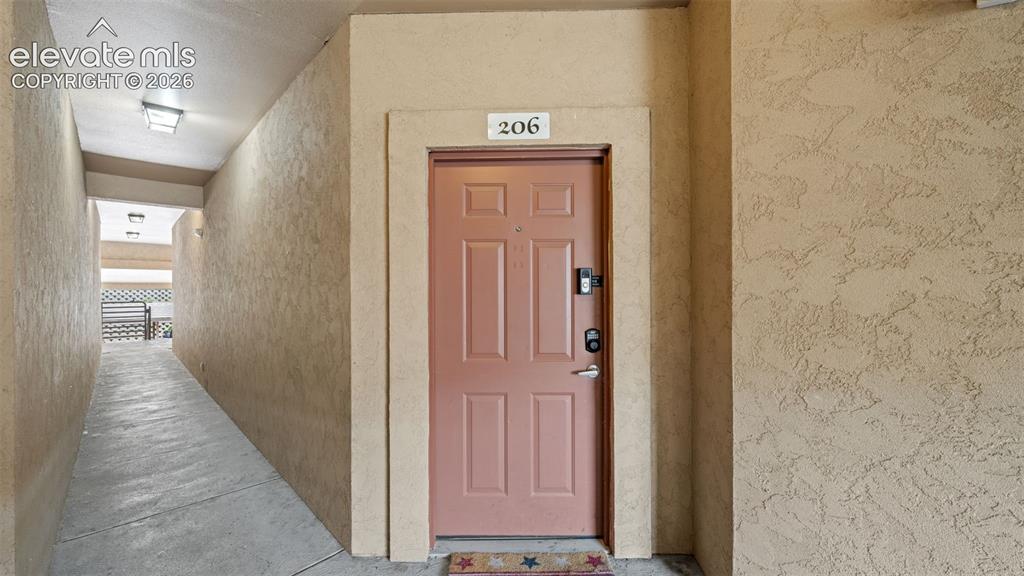 Image 4 of 33: Entry door with panel detailing and modern digital lock
