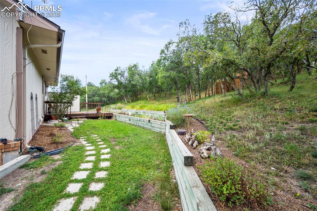 Image 19 of 22: View of yard looking toward deck.