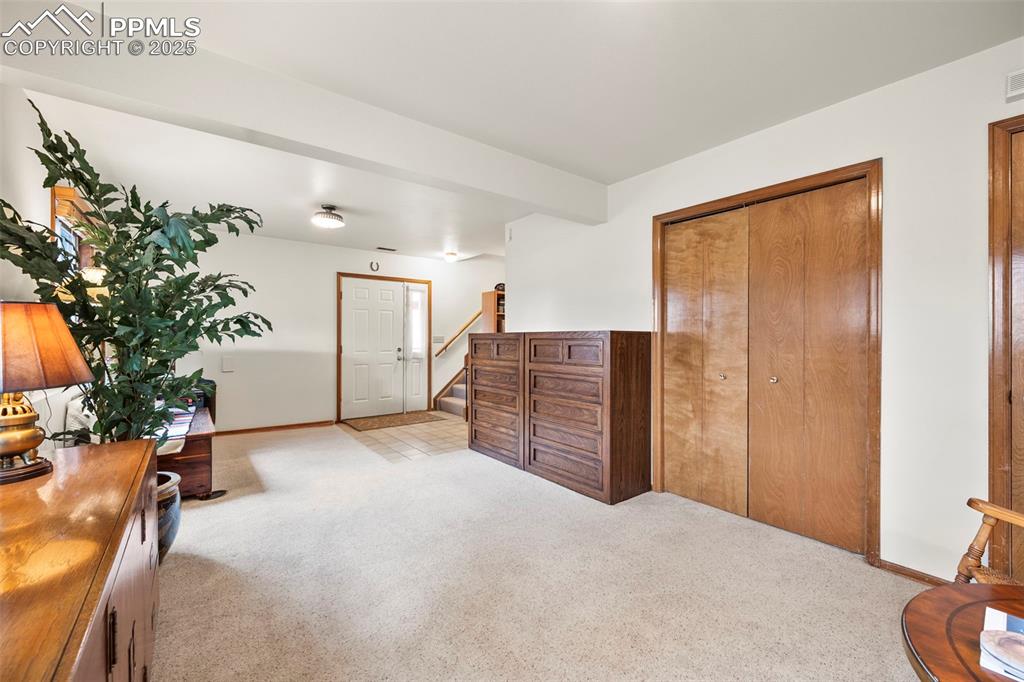 Image 6 of 22: Looking back toward entry and stairs to upper level.