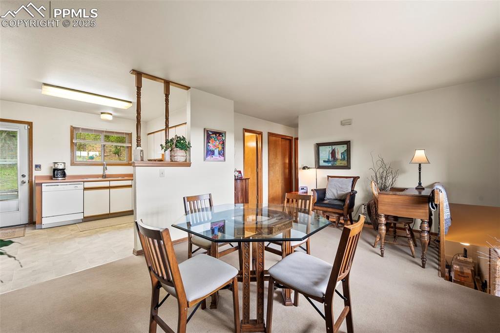 Image 8 of 22: Upper level living area currently being used as dining and sitting area.  D