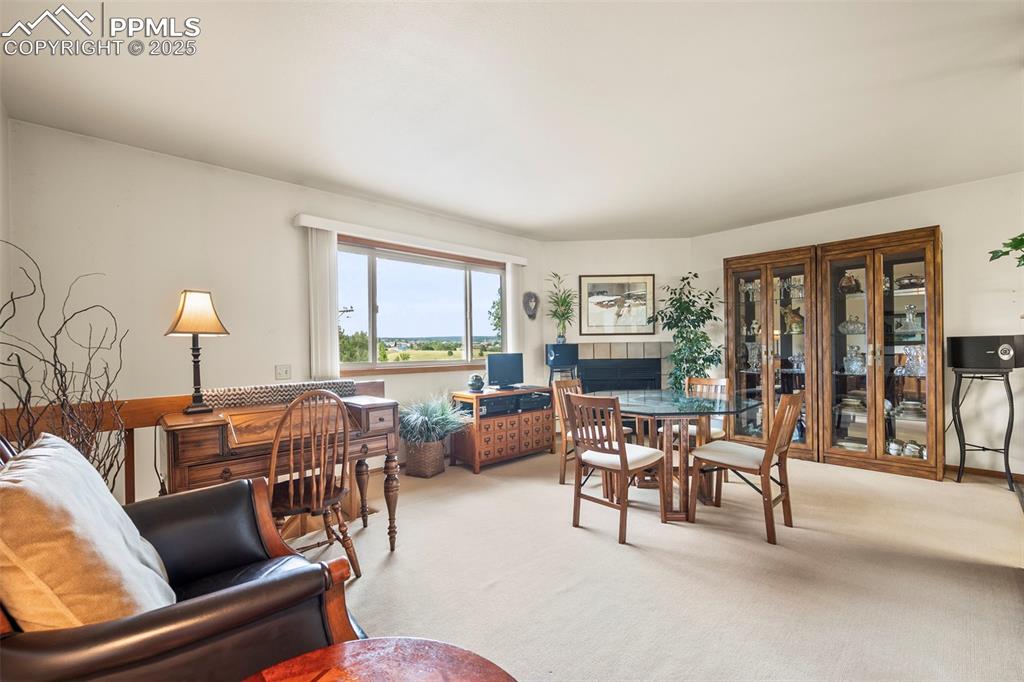 Image 9 of 22: Upper level features fireplace, open feel with lots of natural light.