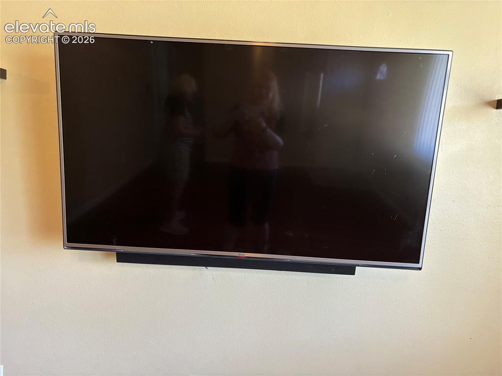 Image 15 of 18: Living room has a large screen tv with sound bar, included!
