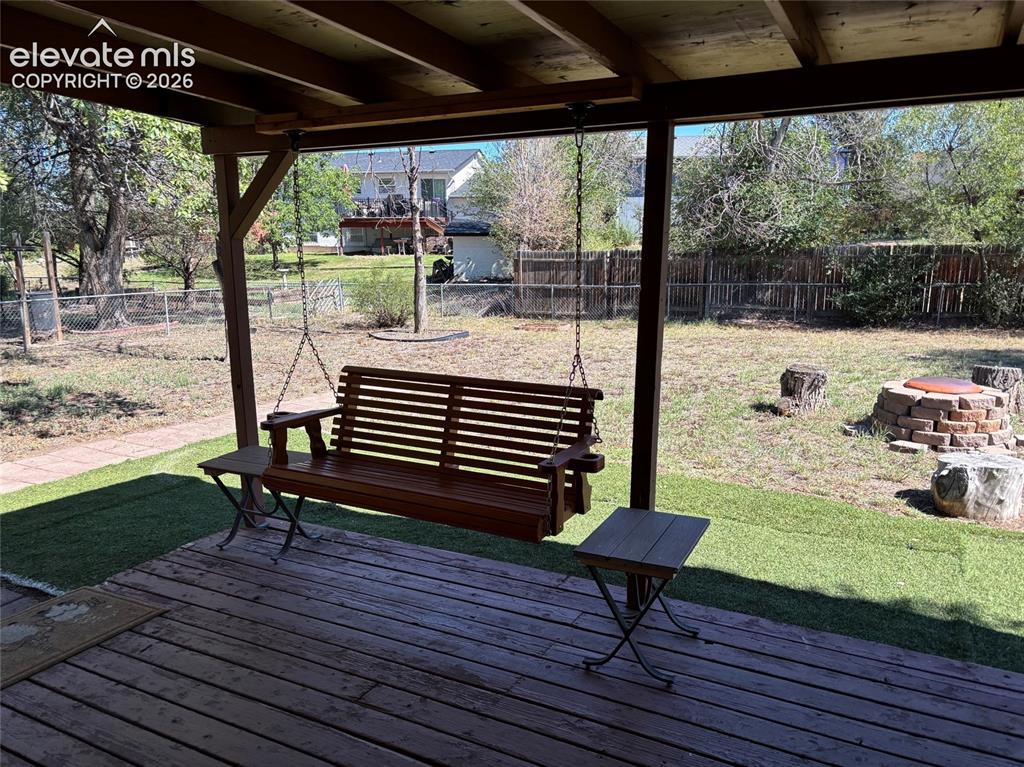 Image 18 of 18: Amazing, peaceful, useable backyard.  The wooden swing is included!  Covere