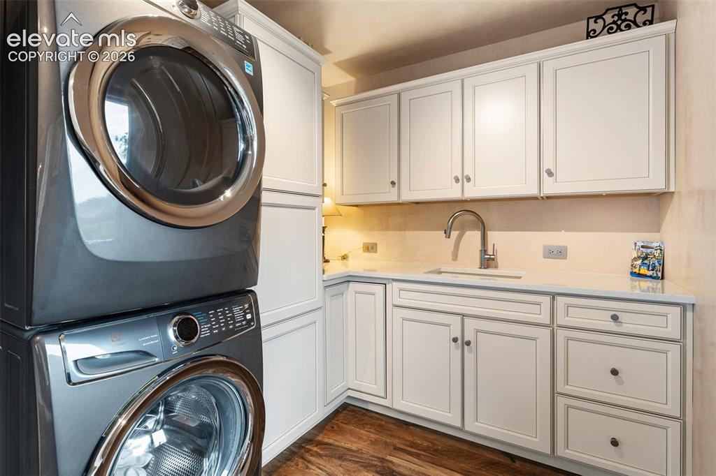 Image 31 of 50: Custom laundry room walks out to garden area