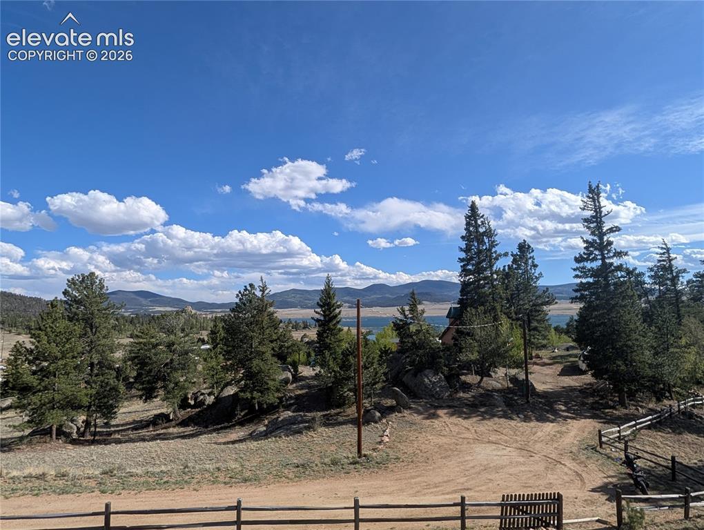 Image 33 of 42: Expansive natural landscape featuring a distant body of water and mountain