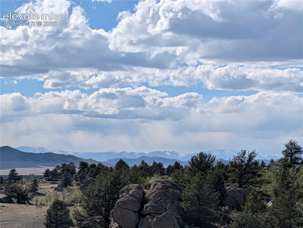Image 36 of 42: Expansive natural landscape featuring a prominent rock formation, numerous