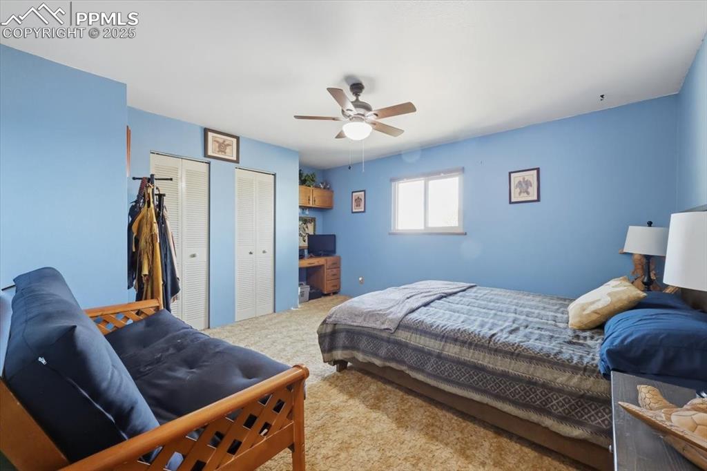 Image 12 of 49: Main floor bedroom #2 with dual closets and built in desk area