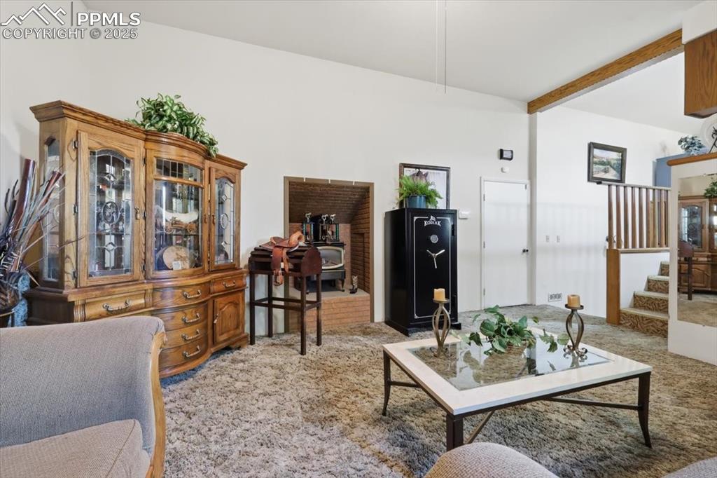 Image 15 of 49: Lower level family room has a free standing wood stove, door to the garage,